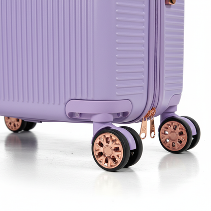 Close-up of purple suitcase rose gold spinner wheels and zipper