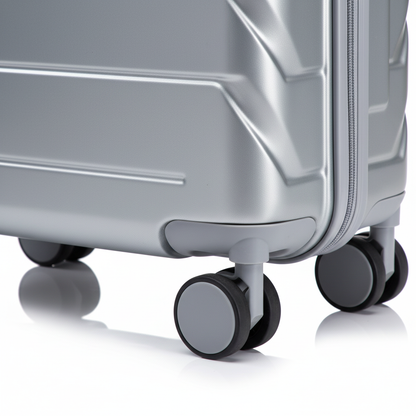 Close-up of silver suitcase TSA lock and spinner wheels