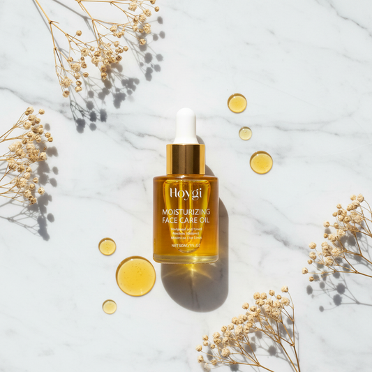 Hoygi Face Care Oil — gold marble flatlay with dried flowers