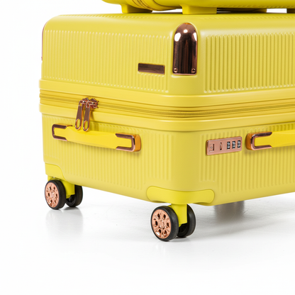 Close-up of yellow suitcase rose gold spinner wheels and zipper